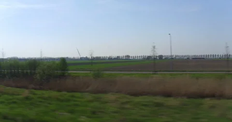Fast train passing rural field in Holland Stock Footage 91336849