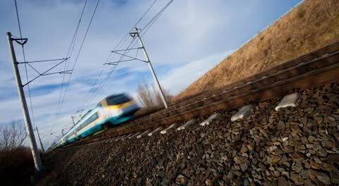 Fast train passing under a bridge on a lovely summer day (motion 스톡 사진