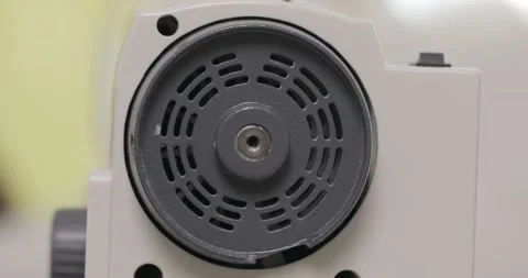 Fast turning handwheel of a sewing machine. overlock wheel turns quickly Video stock 171609417
