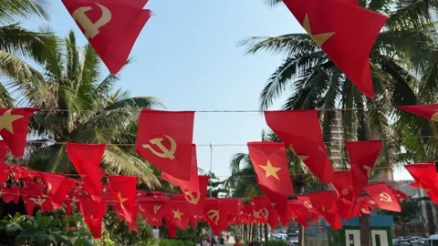 Fast walking motion under Vietnamese and Communist Party small flags waving on Vidéo 342220006