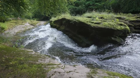 Fast water flow in a river down a small waterfall Stock Footage 158149164