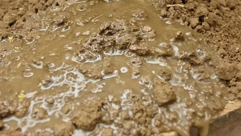 Fast water flowing over bare soil illustrating flood risk and mountain eros.. Stock Footage 325117385