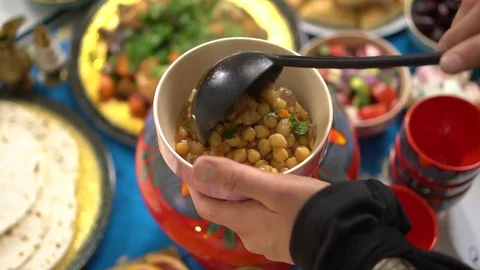 Fasting during Ramadan. Iftar or fatoor, evening meal. Authentic Moroccan Harira Stock Footage 128681436