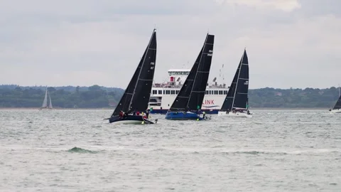 Fastnet Race Sailing Yachts Passing Wightlink Ferry off Isle of Wight Stock Footage 336278640