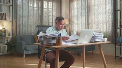 Fat Asian Man With Laptop Drinking Water While Working Hard With Documents Stock Footage 196109906