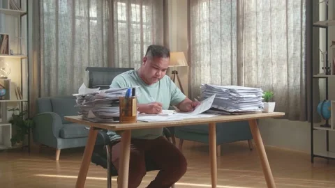 Fat Asian Man Working Hard With Documents At The Office Stock Footage 196109952