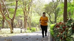 Fat Asian woman wearing a yellow shirt morning exercise in the