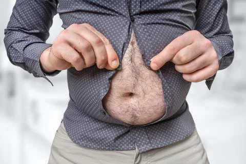 Fat belly of man which does not fit under the shirt - obesity concept Stock Photos