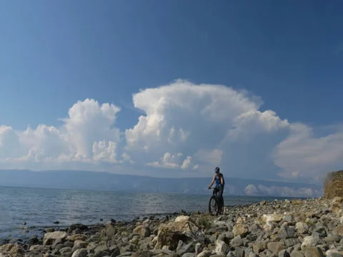 Fat bike also called fatbike or fat-tire bike in summer driving on the beach. Stock Footage