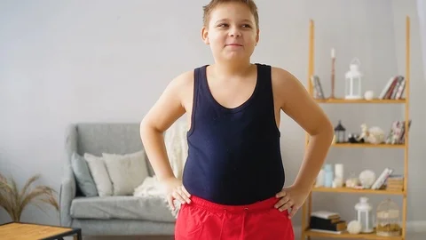 Fat boy doing exercises in the hall Stock Footage 100145527