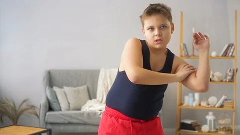 Fat boy doing exercises in the hall Stock Footage 100145670