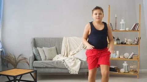 Fat boy doing exercises in the hall Stock Footage 100146079