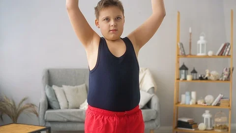 Fat boy doing exercises in the hall Stock Footage 104275936