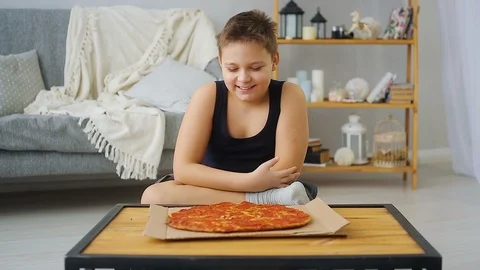 Fat boy eating pizza Stock Footage 100146775