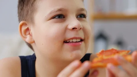 Fat boy eating pizza Stock Footage 100149178