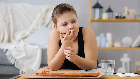 Fat boy eating pizza Stock Footage 100149681