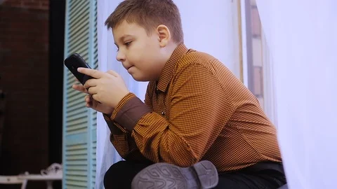 Fat boy playing on smartphone Stock Footage 99938717