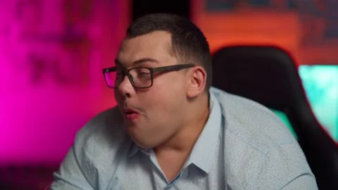 The Fat gamer plays at the computer and eats a burger and pizza. A Thick program Stock Footage 220419976