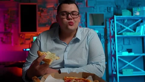The Fat gamer plays at the computer and eats a burger and pizza. A Thick program Stock-Footage 220419989