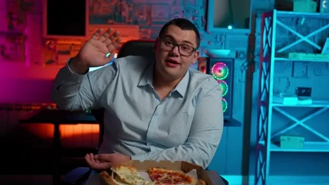 The Fat gamer plays at the computer and eats a burger and pizza. A Thick program Stock Footage 220420052