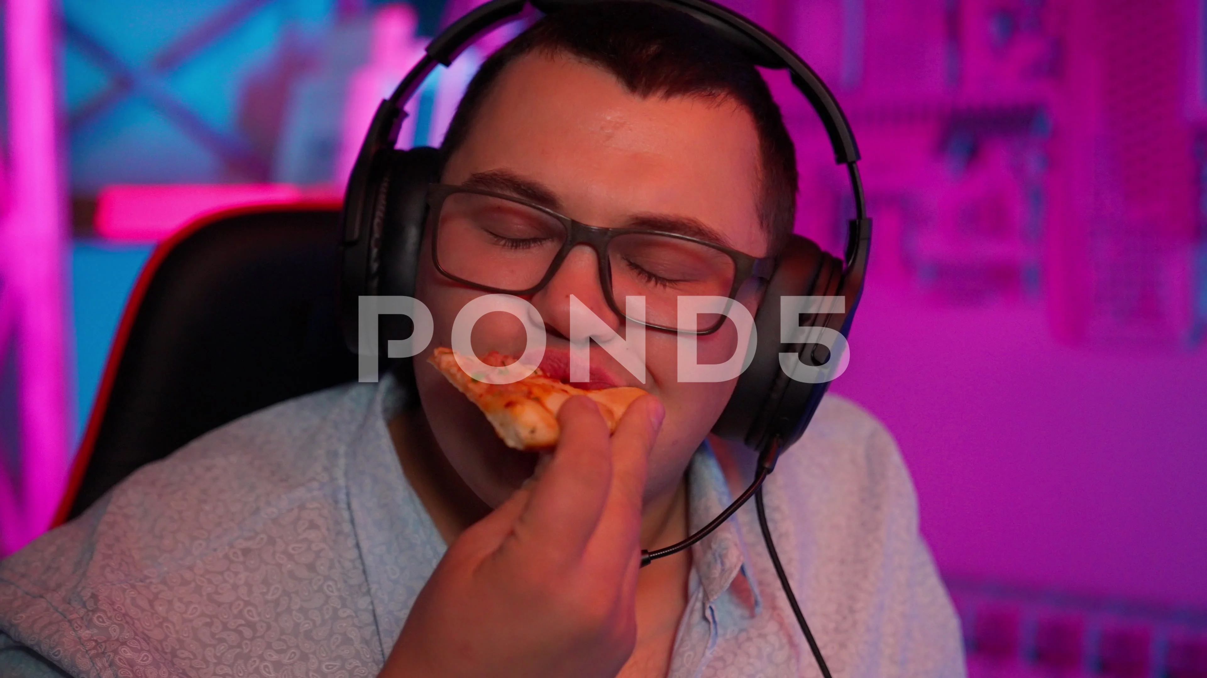 The Fat gamer plays at the computer and eats a burger and pizza. A Thick  program