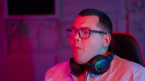 The Fat gamer plays at the computer and eats a burger and pizza. A Thick program Stock Footage 220420639