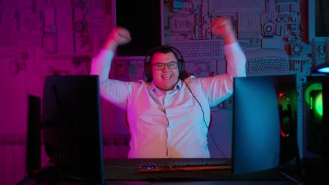 The Fat gamer plays at the computer and eats a burger and pizza. A Thick program Stock Footage 220420837