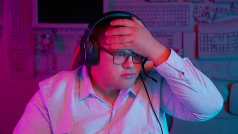 The Fat gamer plays at the computer and eats a burger and pizza. A Thick program Stock Footage 220420841