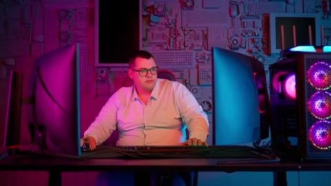 The Fat gamer plays at the computer and eats a burger and pizza. A Thick program Stock Footage 220422196