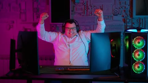 The Fat gamer plays at the computer and eats a burger and pizza. A Thick program Stock Footage 220423890