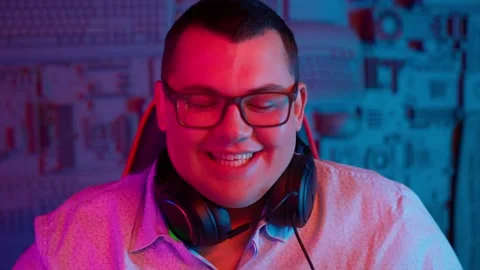 The Fat gamer plays at the computer and eats a burger and pizza. A Thick program Stock Footage 220423950