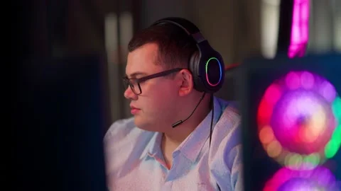 The Fat gamer plays at the computer and eats a burger and pizza. A Thick program Stock Footage 220424048