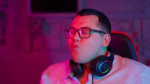 The Fat gamer plays at the computer and eats a burger and pizza. A Thick program Stock Footage 220424310