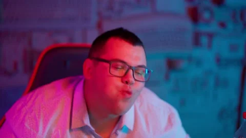 The Fat gamer plays at the computer and eats a burger and pizza. A Thick program Stock Footage 220424352