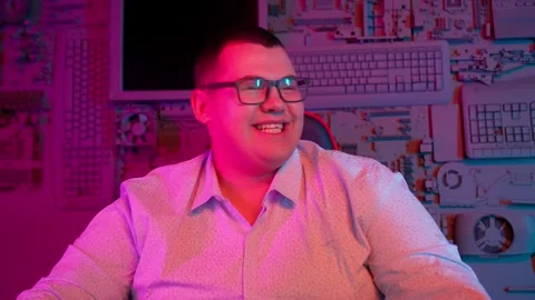 The Fat gamer plays at the computer and eats a burger and pizza. A Thick program Stock-Footage 220545763