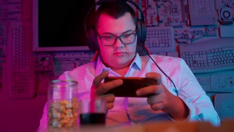 The Fat gamer plays at the computer and eats a burger and pizza. A Thick program Stock Footage 220545822