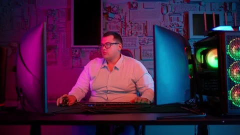The Fat gamer plays at the computer and eats a burger and pizza. A Thick program Stock Footage 220545898
