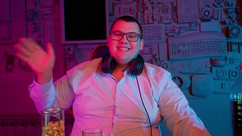 The Fat gamer plays at the computer and eats a burger and pizza. A Thick program Stock Footage 220545906