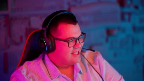 The Fat gamer plays at the computer and eats a burger and pizza. A Thick program Stock Footage 220545994