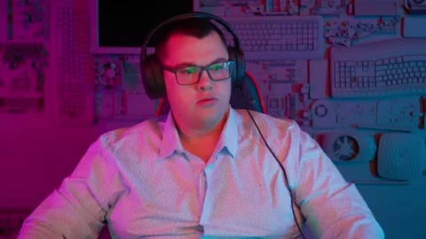 The Fat gamer plays at the computer and eats a burger and pizza. A Thick program Stock Footage 220546830