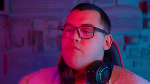 The Fat gamer plays at the computer and eats a burger and pizza. A Thick program Stock Footage 220546853