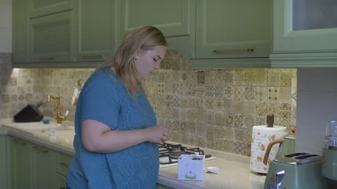 Fat girl in the kitchen Stock Footage 111588347