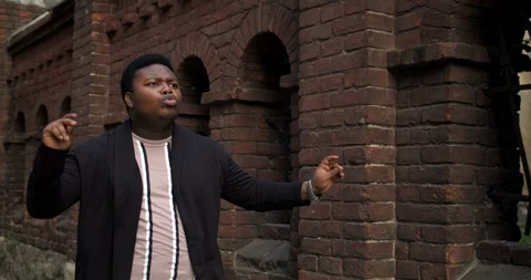 Fat guy doing funny movements at street. Stock Footage 121213490