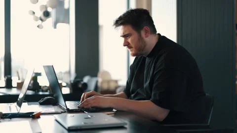 A fat IT guy writes a program, codes a mobile application, possibly a hacker Stock Footage 173479490