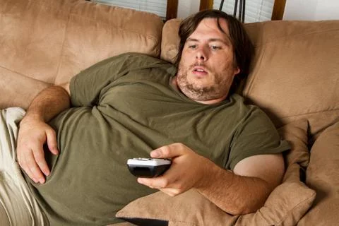 Fat lazy guy on the couch Stock Photos
