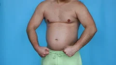 An overweight man demonstrates a big bel, Stock Video