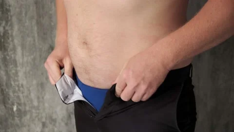 Fat man can't button your pants due to prevent stomach.Jumping and trying to Stock Footage 141909782