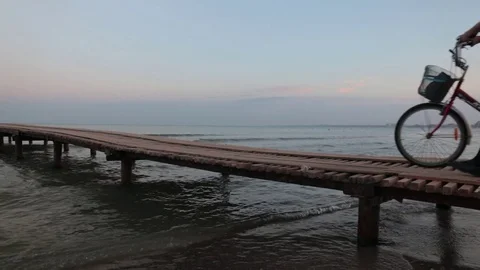 Fat man with a creative bike goes on the pier with his back to us. Stock Footage 80221121
