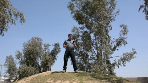 Fat man dancing on the nature. man on a hill dancing and use smartphone Stock Footage 105829776