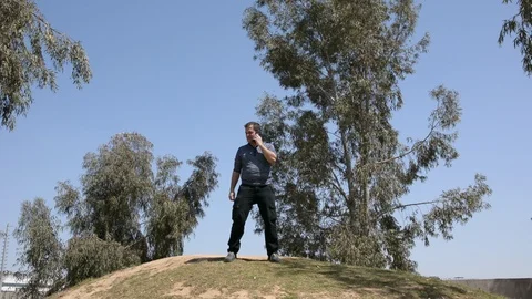 Fat man dancing on the nature. man on a hill dancing and use smartphone Vídeo Stock 105830738